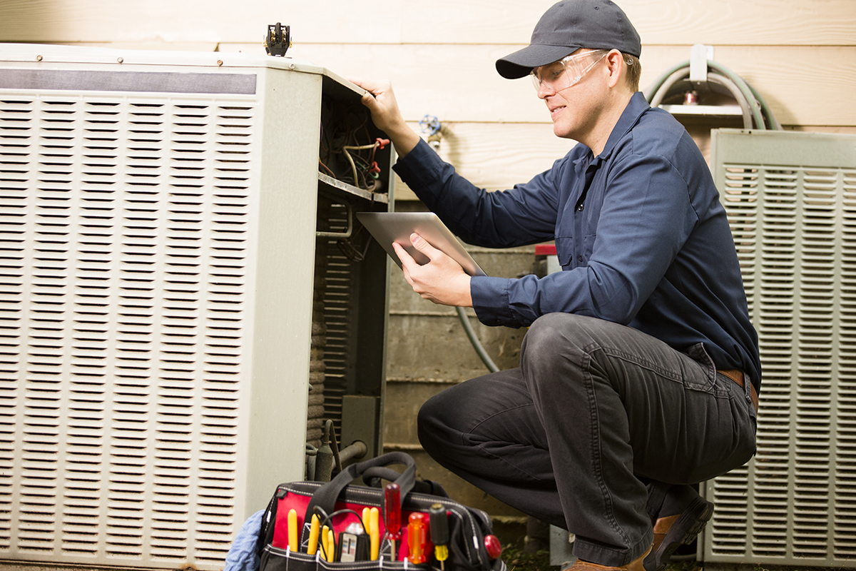 Electrician working on air conditioner